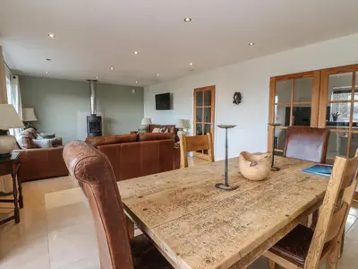 a dining room with a wooden table and chairs at Lurach House in Appin