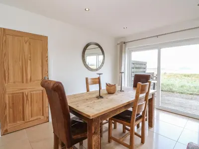 a dining room with a wooden table and chairs at Lurach House in Appin