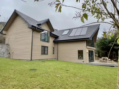 a house with solar panels on the roof at Highland House in Lochearnhead