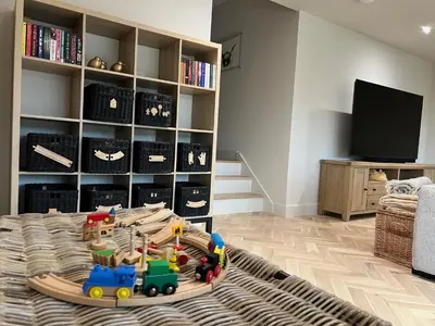 a living room with a toy train on a rug at Highland House in Lochearnhead