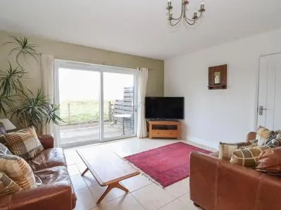a living room with a couch and a television at Sealladh in Appin