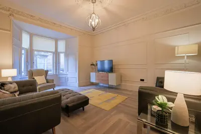 a living room with a couch and a tv at Gordon's Getaway Lux in Oban