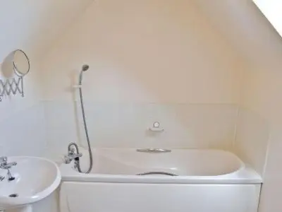 a white bathroom with a tub and a sink at Holiday Home Gehöft 4 by Interhome in Tweedsmuir