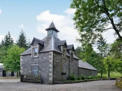 a building with a clock tower on top of it at Holiday Home Gehöft 4 by Interhome in Tweedsmuir
