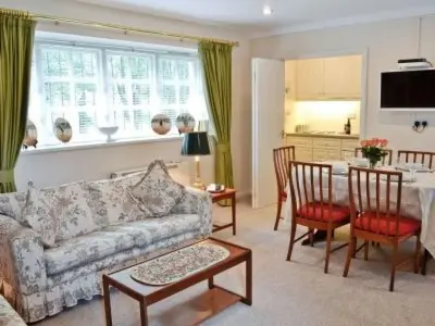 a living room with a couch and a table at Holiday Home Gehöft 4 by Interhome in Tweedsmuir