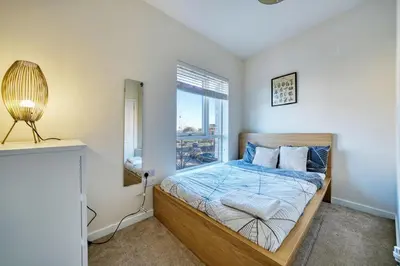 a bedroom with a bed and a window at Stylish and Morden 3Bed House Glasgow City Centre in Glasgow