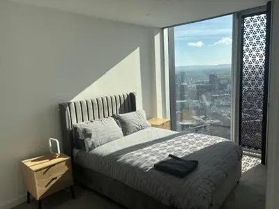 a bedroom with a large bed and a large window at Skyline view 2 bedroom apartment in Moffat