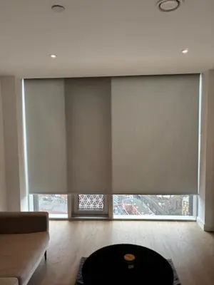 a living room with a large window with white blinds at Skyline view 2 bedroom apartment in Moffat