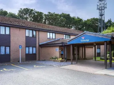 an empty parking lot in front of a building at Travelodge Edinburgh Dreghorn in Edinburgh