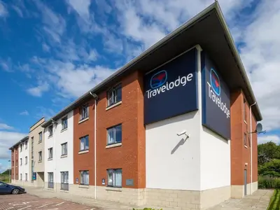 a building with a sign on the side of it at Travelodge Falkirk in Polmont