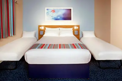 a pair of beds in a hotel room at Travelodge Kinross M90 in Kinross
