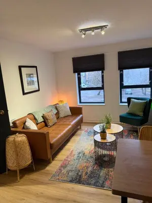 a living room with a couch and a table at 2BR Sleeps 4 Albion Gate Glasgow City Centre in Glasgow