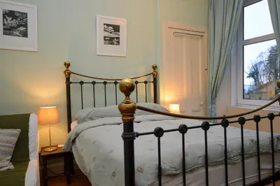 a bedroom with a bed and a window at Montford Shore in Rothesay