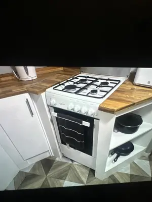 a kitchen with a stove and a counter top at Sandylands caravan park in Stevenston