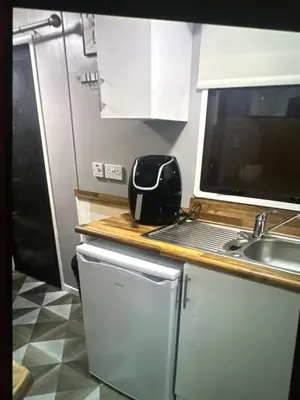 a kitchen with a sink and a toaster on a counter at Sandylands caravan park in Stevenston