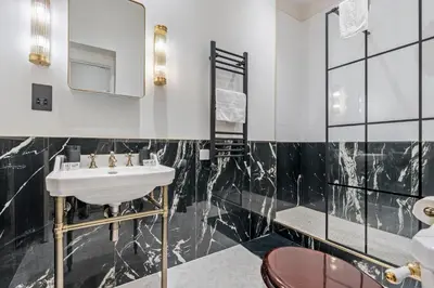 a bathroom with a sink and a mirror at Central Jewellery Quarter 1-Bedroom with Parking in Moffat