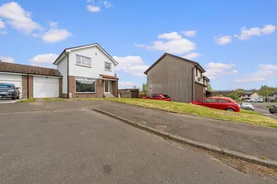 an empty parking lot in front of a house at The Brora in High Blantyre