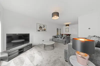 a living room with a couch and a table at The Brora in High Blantyre