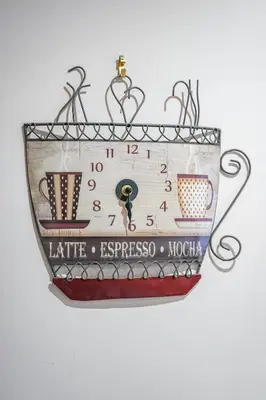 a clock with cups on it hanging on a wall at Jake's House in Airdrie