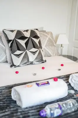 a bed with two towels and hearts on it at Jake's House in Airdrie
