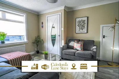 a living room with a couch and a chair at Ochil View House in Falkirk