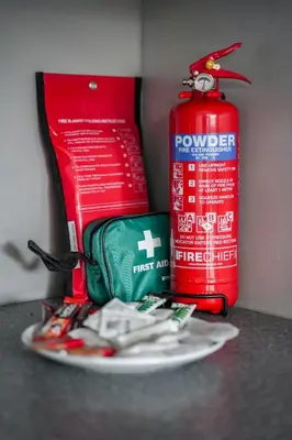 a plate with tongs and a fire extinguisher next to a red bottle at Ochil View House in Falkirk