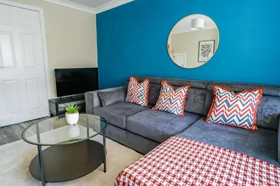 a living room with a couch and a table at Ochil View House in Falkirk