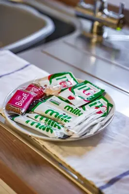 a plate of toothpaste and toothbrushes on a counter at Cambridge Apartment in Glasgow