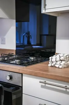a kitchen with a stove and a counter top at Cambridge Apartment in Glasgow