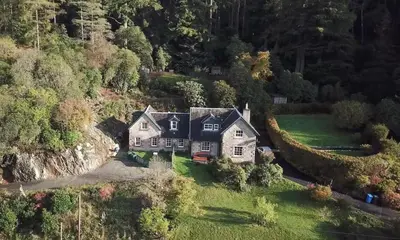 an aerial view of a house on a hill at 3 Bed House - Mountain Views Bbq Firepit in Dunoon