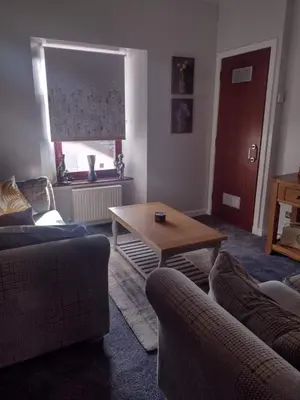 a living room with two couches and a coffee table at Driftwood in Largs