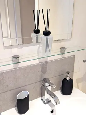 a glass shelf above a sink in a bathroom at Balmore - 3 Bedroom Townhouse, heart of Killin in Killin