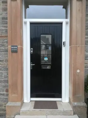 a black door of a building with a sign on it at Balmore - 3 Bedroom Townhouse, heart of Killin in Killin