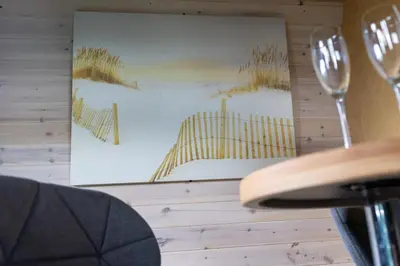 a picture hanging on a wall with two wine glasses at Highland Gateway Glamping in Clackmannan