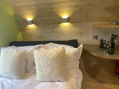 a bedroom with a bed with two pillows on it at Highland Gateway Glamping in Clackmannan