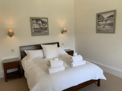a bedroom with a bed with towels on it at The Tractor Shed- Elevated Hot Tub with Loch Views