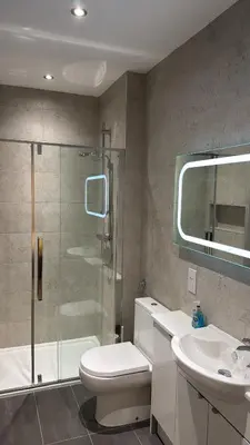 a bathroom with a shower and a toilet and a sink at Edinburgh West Residence in Edinburgh