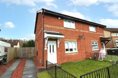 a red brick house with a white door at Signature Summerhill House in Bearsden