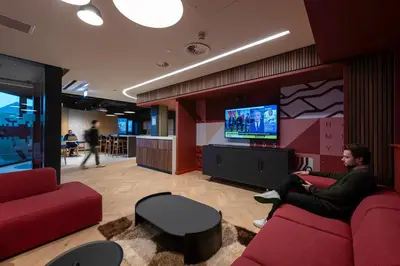 a man sitting on a couch in a room with a tv at For Students Only - Haymarket Yard in Edinburgh in Edinburgh
