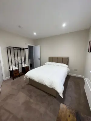 a bedroom with a large white bed in it at Skips in Largs
