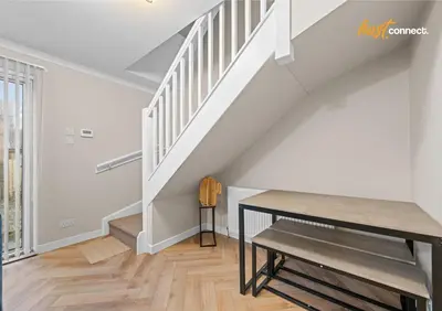 a dining room with a table and stairs at 2 Bed Home in Paisley I Sleeps 4 in Paisley