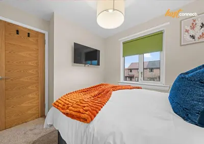 a bedroom with a bed and a window at 2 Bed Home in Paisley I Sleeps 4 in Paisley