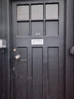 a black door with the number on it at The Boswall Residence in Edinburgh