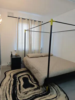 a bedroom with a bed with a black frame at The Boswall Residence in Edinburgh