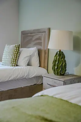 a bedroom with two beds and a lamp on a table at Dunward House in Livingston