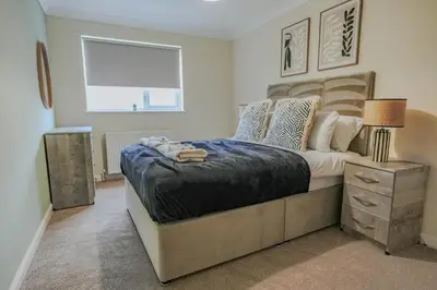 a bedroom with a large bed and a window at Dunward House in Livingston