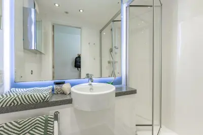 a bathroom with a white sink and a mirror at For Students Only - Dunaskin Mill in Glasgow in Glasgow
