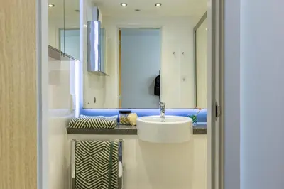 a bathroom with a sink and a mirror at For Students Only - Dunaskin Mill in Glasgow in Glasgow