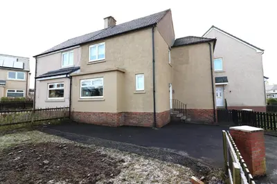 a house with a driveway in front of it at Signature Greenfield House in Wishaw