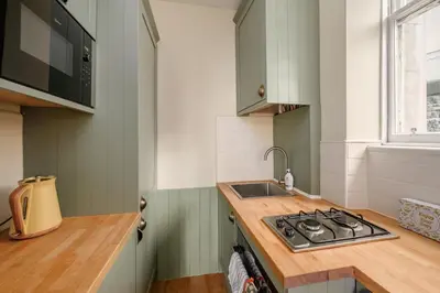 a kitchen with a stove and a sink at Quiet 1-Bed Flat by the Meadows in Edinburgh